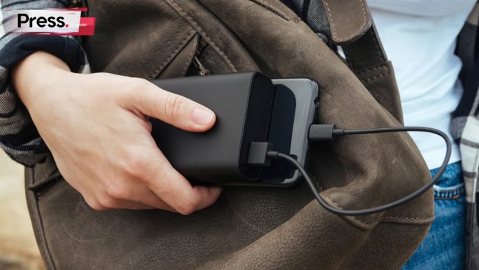 a-girl-hands-holding-a-powerbank-that-charging-the-phone