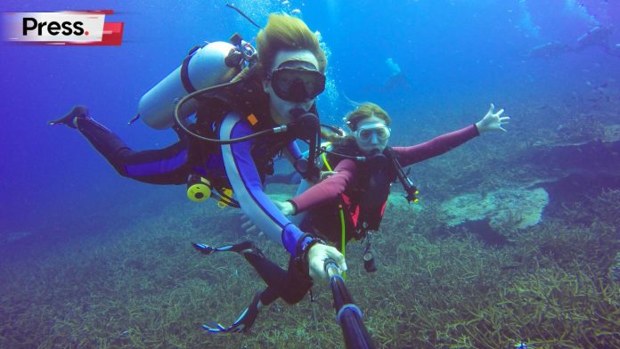 two scuba divers with driving license in the waters of malaysia