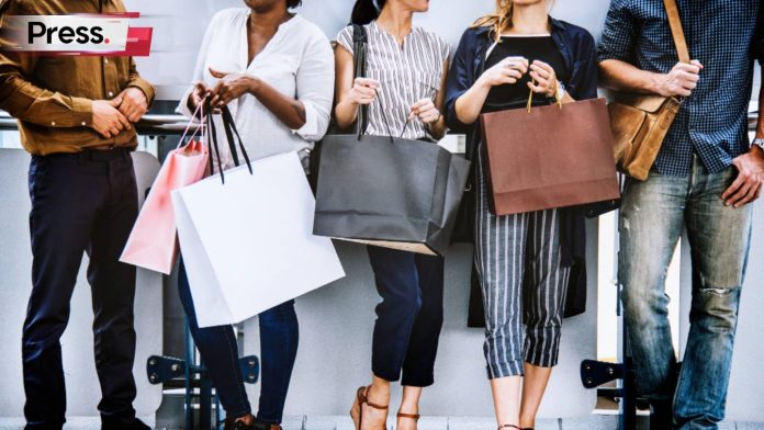A group of friends, 3 women and 2 men, standing close by each other while holding their shopping bags. We can't see their faces, but they are clearly happy as they linger and talk to each other about their purchases. Small business SEO can help track the behaviour of customers like this.