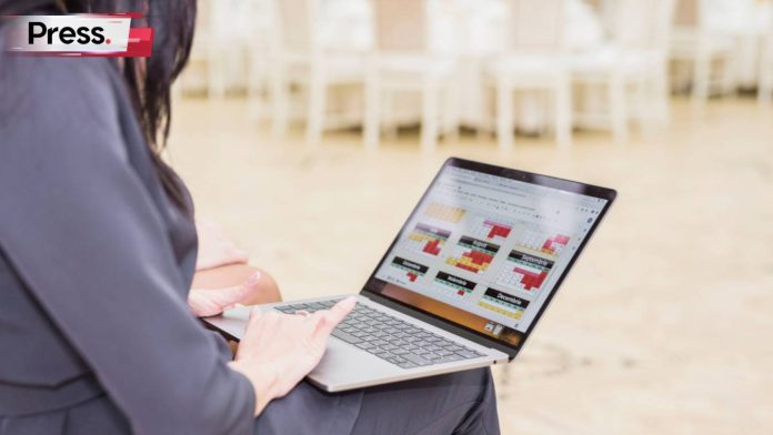 A businesswoman sits staring at her laptop, analyzing the homepage of a website and figuring out how to do on page SEO in Malaysia.