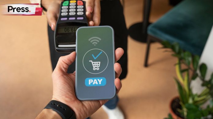 Customer using smartphone for contactless payment through POS terminal, illustrating Malaysia’s top payment gateways and digital transactions.