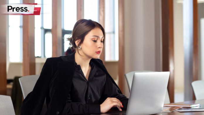 A businesswoman sits at her desk studying the best options for SEO tools in Malaysia.