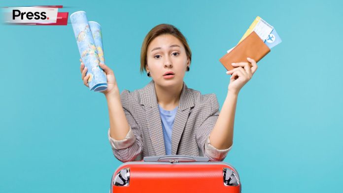 A female planning vacation holding map wallet and tickets on blue background with Press logo top left.