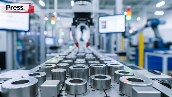 Automated robotic arm on a production line with metallic cylindrical parts in a modern manufacturing facility.
