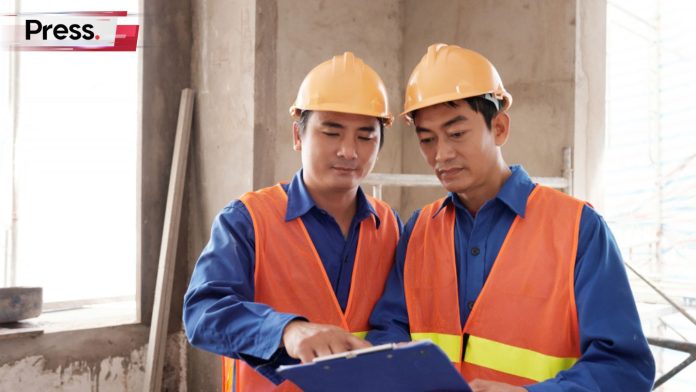 Two engineers discuss how they can hire a new foreign worker for their company
