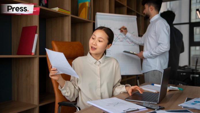 Two colleagues work on a report about their company's local SEO efforts.