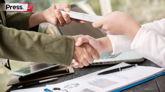 A photo of two men shaking hands, as one of them successfully receives a personal loan.