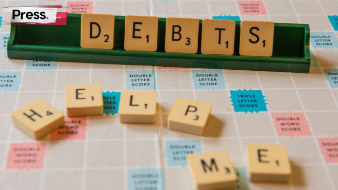 A picture of scrabble tiles that spell out 'DEBT' and 'HELP ME', representing debt consolidation
