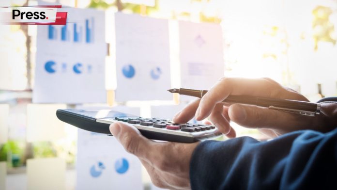 Photo of a person calculating their budget on a calculator