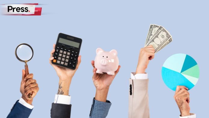 A row of hands raised in the air. The hands are holding a magnifying glass, a calculator to calculate income, a piggy bank, money, and a pie chart.