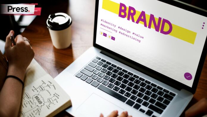 Photo of a laptop with the word 'Brand' on the screen, representing brand slogans