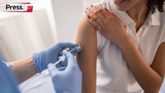 Photo of a woman getting vaccinated, symbolizing healthcare stocks