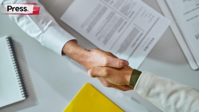 Two people shaking hands at a recruitment agency in Malaysia