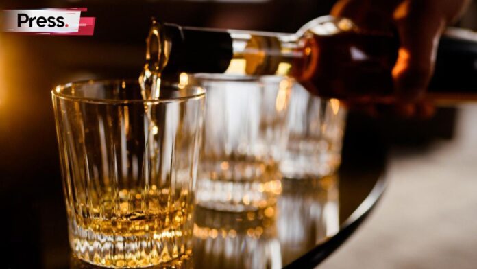 Photo of a person pouring alcohol into a glass, symbolizing a liquor license in Malaysia
